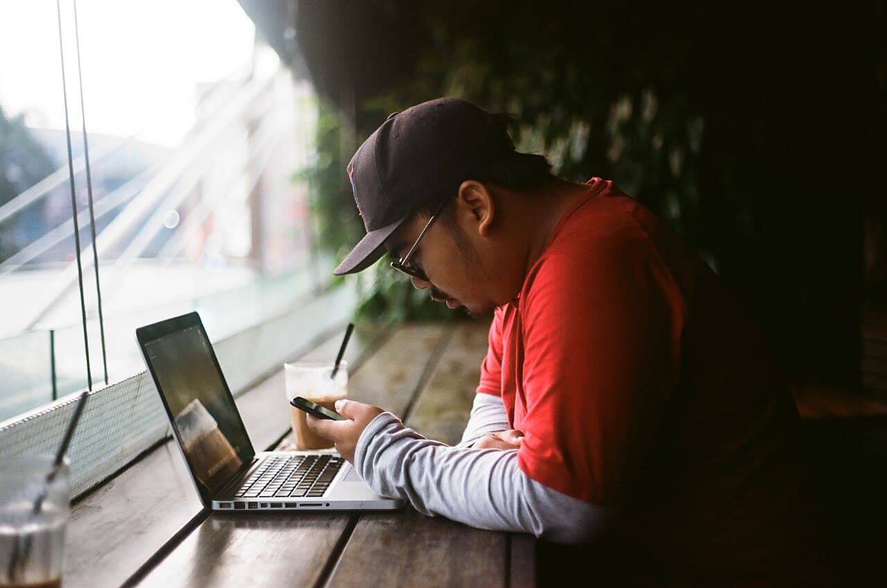 A person using a laptop at a cafe in Jakarta, Indonesia.